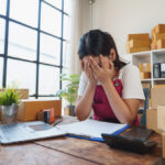 Small business owner exhausted at desk — Bradford Business Coaching blog on business design and freedom