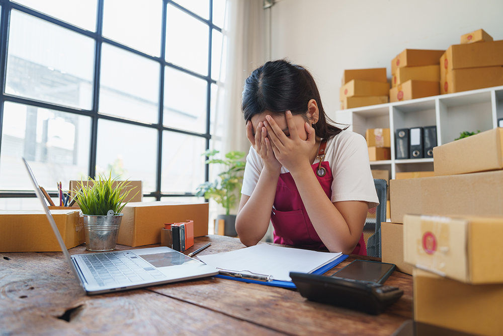 Small business owner exhausted at desk — Bradford Business Coaching blog on business design and freedom